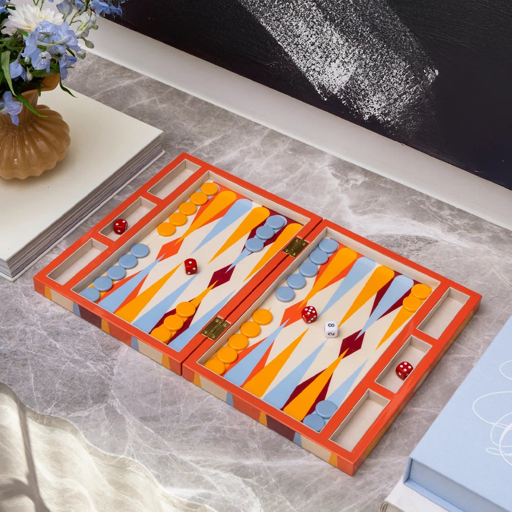 Colorful backgammon set on a marble surface with decorative elements.