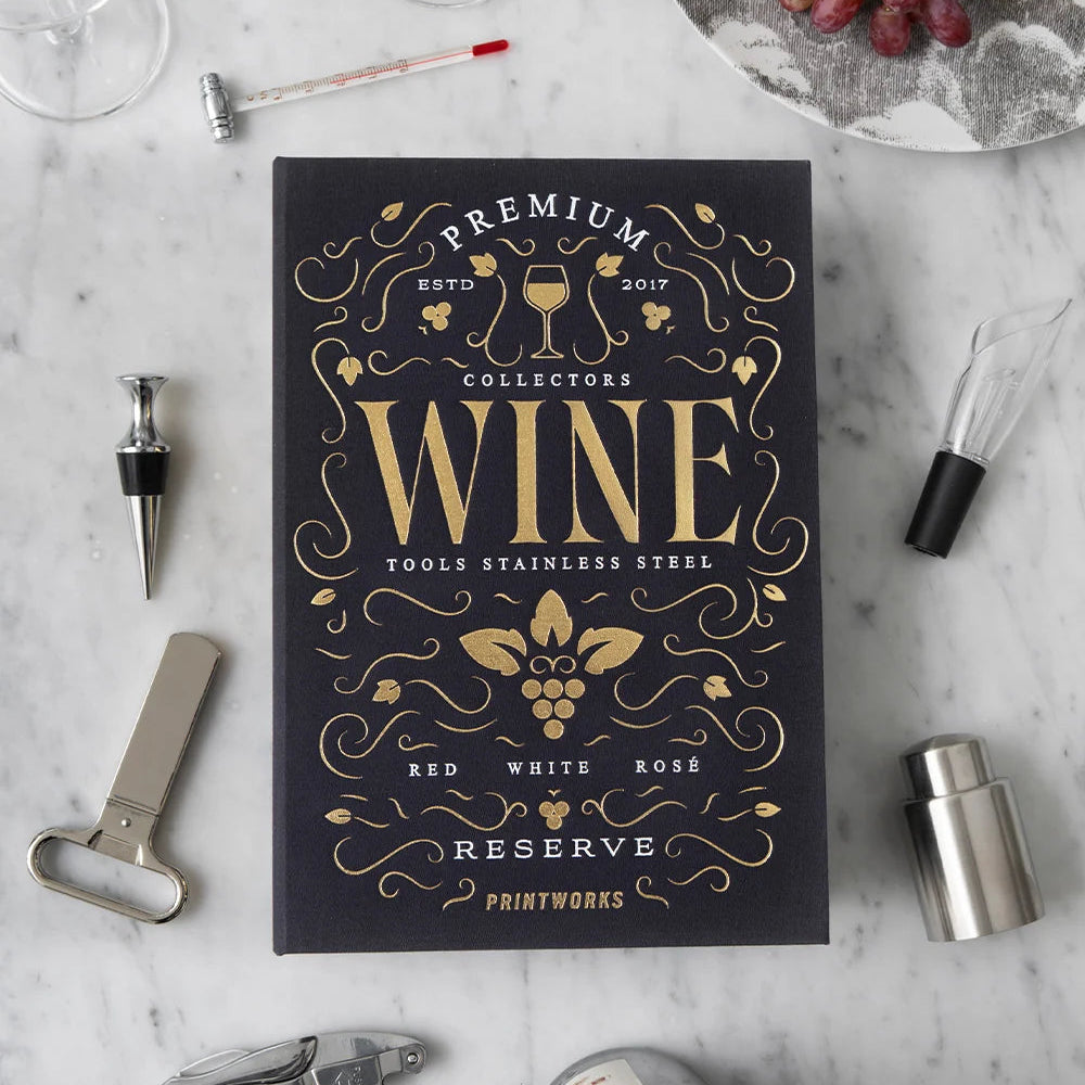 Wine-themed box with decorative text on a marble surface with wine accessories.