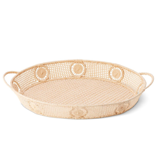Woven raffia tray with decorative handles on a white background