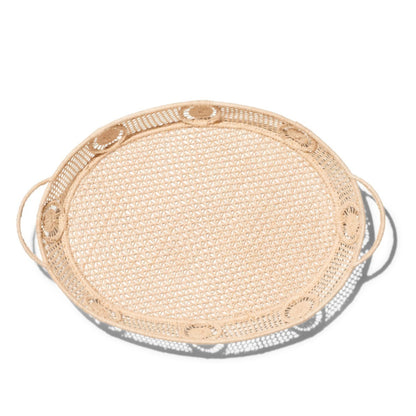 Round woven raffia tray with metallic rim on a white background