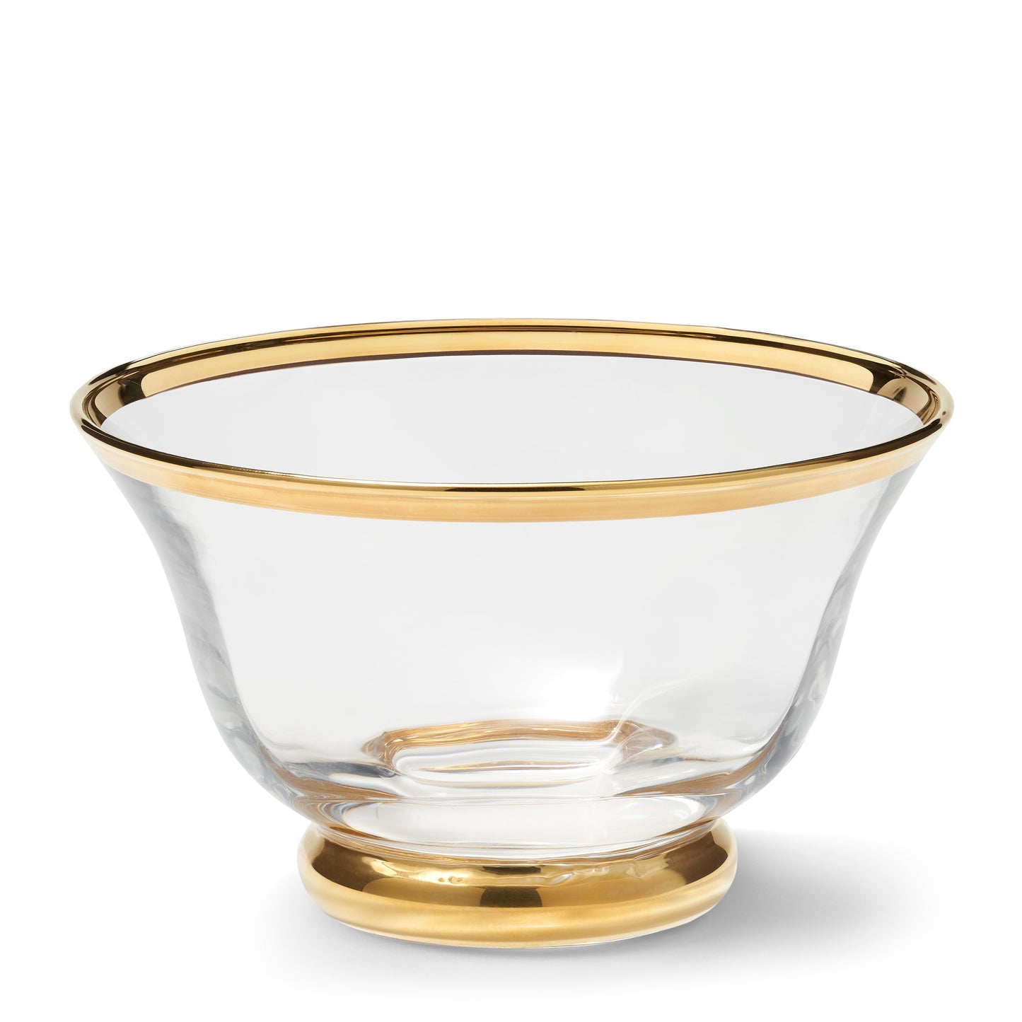 Clear glass bowl with gold rim and base on a white background