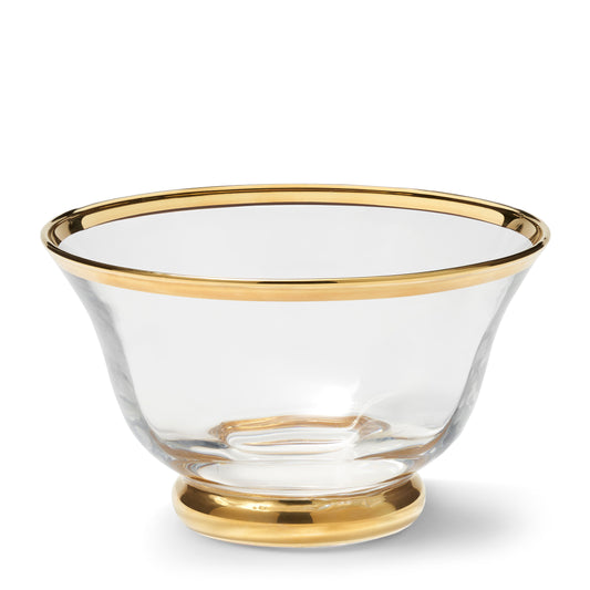 Clear glass bowl with gold rim and base on a white background