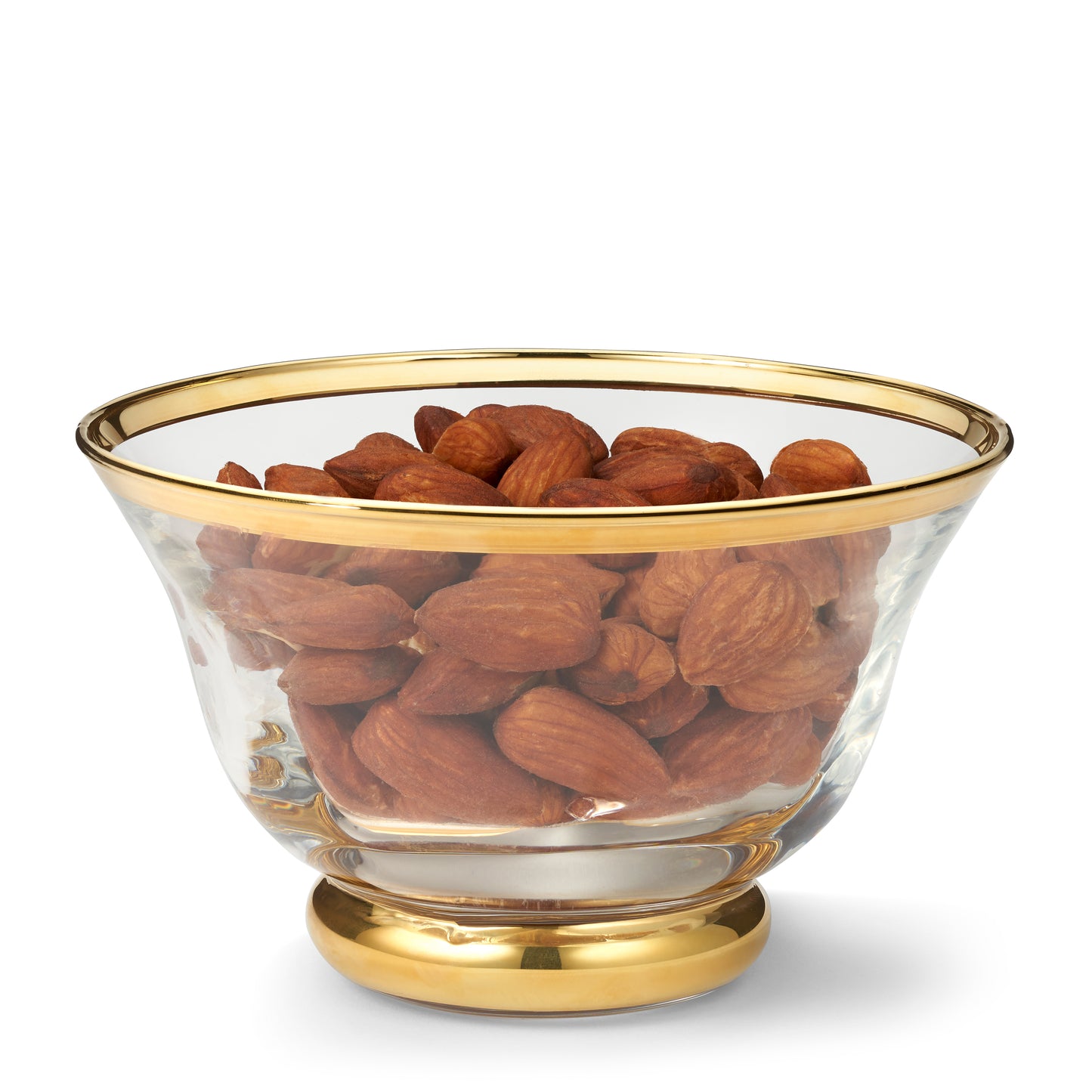 Glass bowl with gold rim and base filled with almonds on a white background