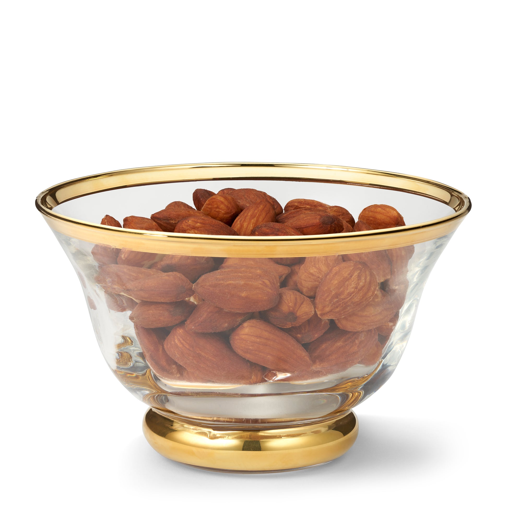 Glass bowl with gold rim and base filled with almonds on a white background