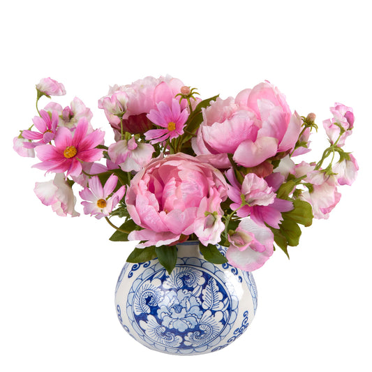 Faux pink flowers in a blue and white decorative vase by Diane James Home on a white background