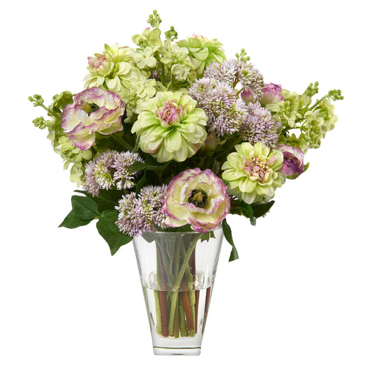Bouquet of green and purple flowers by Diane James Home in a clear vase on a white background
