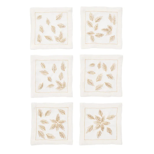 Six square whitelinen napkins arranged in a 3-by-2 grid on a white background. Eachnapkin features embroidered gold leaf motifs and a thingoldborder.