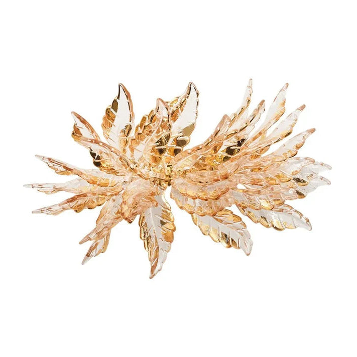 A gold-toned crystal leaf napkin ring with clear faceted crystals arranged in a starburst pattern, shown on a plain white background.