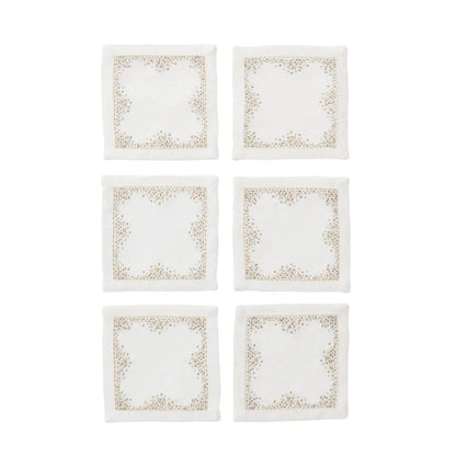Six square white napkins with delicate gold pin dot embroidery along the borders, arranged in a two-column grid on a solid white background.