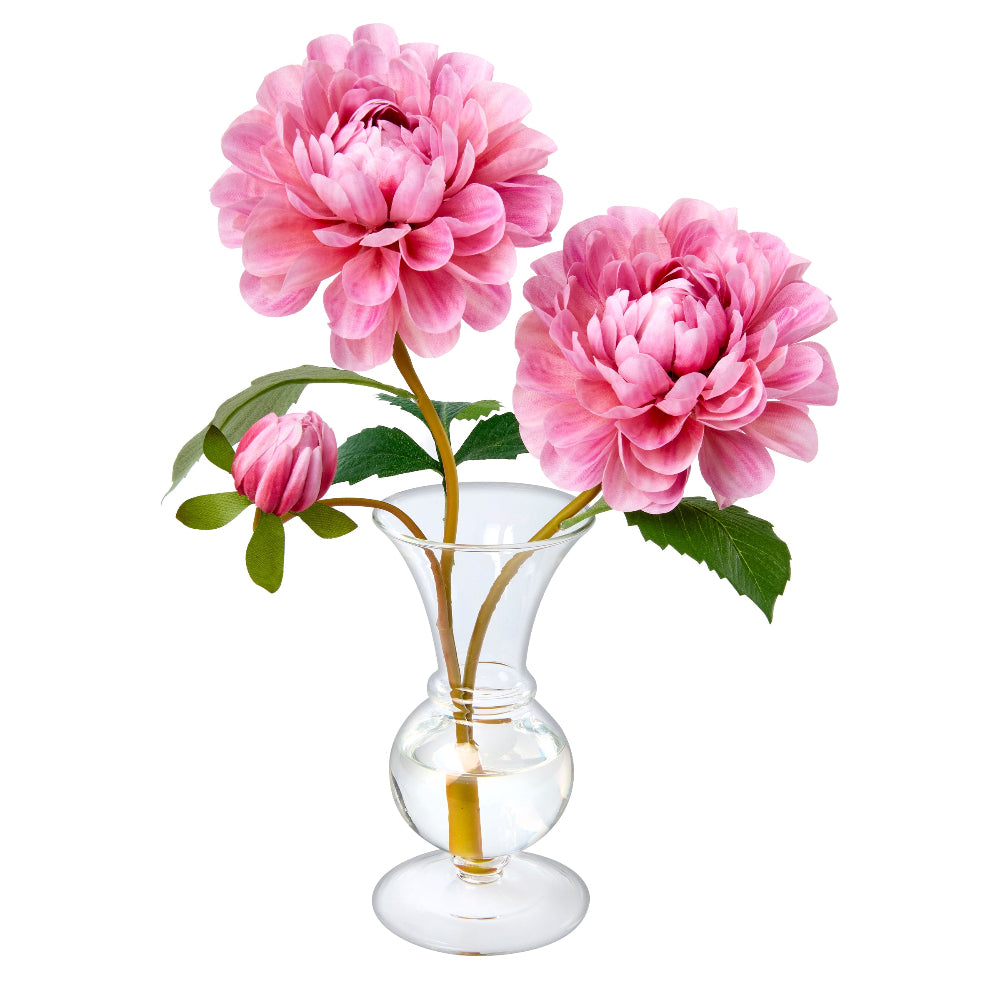 Oh My Darling by Diane James Home is composed of two pink dahlias with green leaves arranged in a clear glass vase on a white background. 