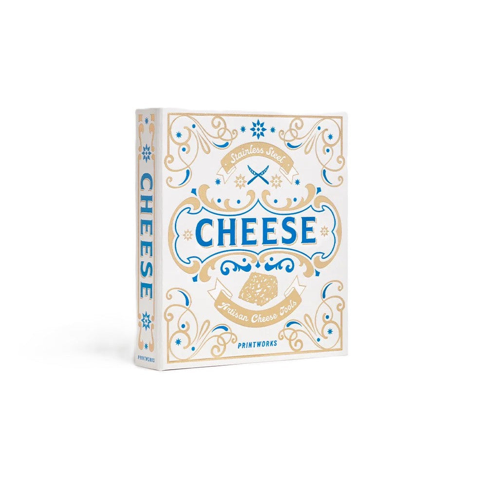 A box with cheese tools by Printworks, featuring a white box with ornate blue and gold vintage-style illustrations and the word 'CHEESE' in large blue letters on the front.