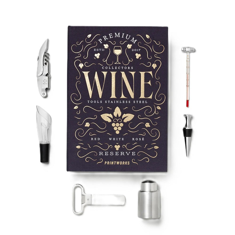 A premium wine tool set displayed on a clean white background, featuring a dark purple collector's book with gold lettering and several stainless steel tools including a corkscrew, wine opener, bottle opener, decanter, and stopper.