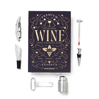 A premium wine tool set displayed on a clean white background, featuring a dark purple collector's book with gold lettering and several stainless steel tools including a corkscrew, wine opener, bottle opener, decanter, and stopper.