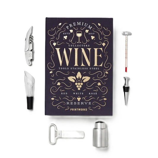 A premium wine tool set displayed on a clean white background, featuring a dark purple collector's book with gold lettering and several stainless steel tools including a corkscrew, wine opener, bottle opener, decanter, and stopper.