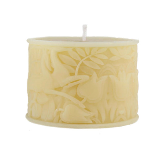 A small cream-colored wax candle with a single white wick, featuring an embossed floral and leaf pattern on its cylindrical side, isolated on a white background.