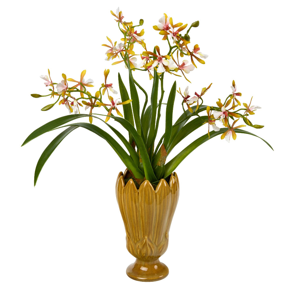 Sunlit Moor is a potted artificial cattleya orchid by Diane James Home with long green leaves, yellow and white flowers with pink accents, and a ribbed flower-shaped mustard-yellow ceramic vase on a plain white background.