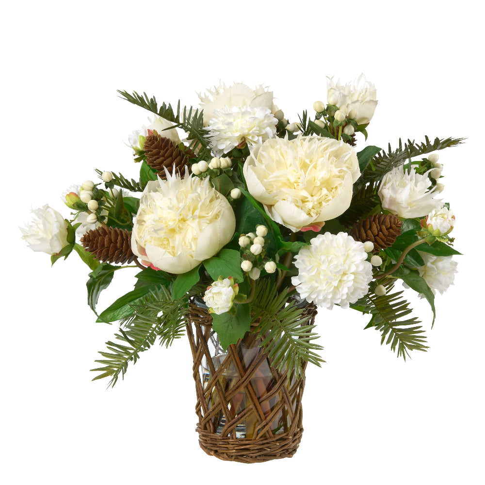 An artificial floral arrangement by Diane James Home featuring white peonies and dahlias, green pine branches, small white berries, and brown pinecones in a woven brown basket vase, isolated on a white background.